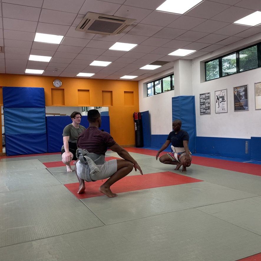 Three members of the London Sumo Club warming up
