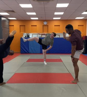 Three members of London Sumo Club warming up
