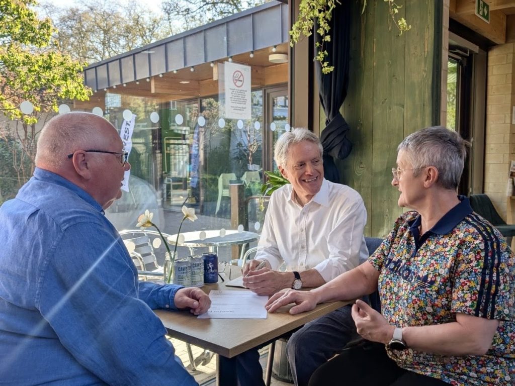 Labour MP Ben Coleman with Putney Bridge Accessibility campaigners Geoff Hadwick and Miriam Busani at a cafe