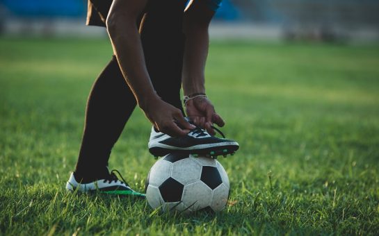Person resting foot on ball