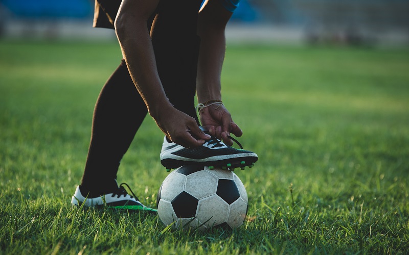Person resting foot on ball