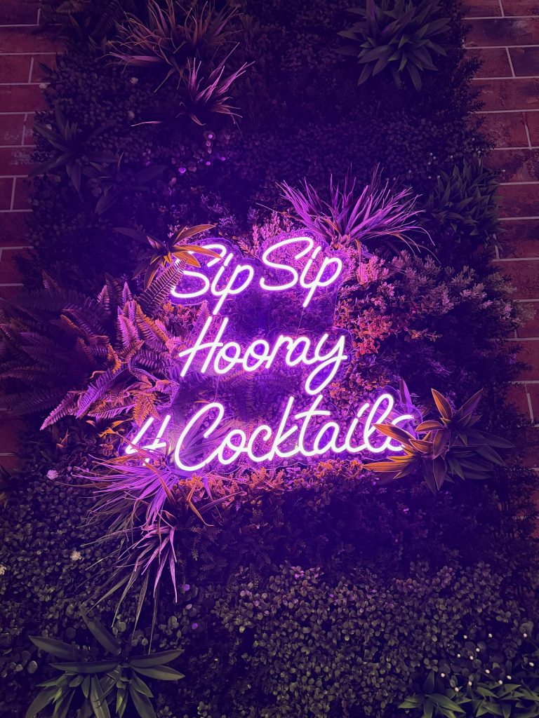 Image of neon sign saying Sip Sip Hooray 4 Cocktails