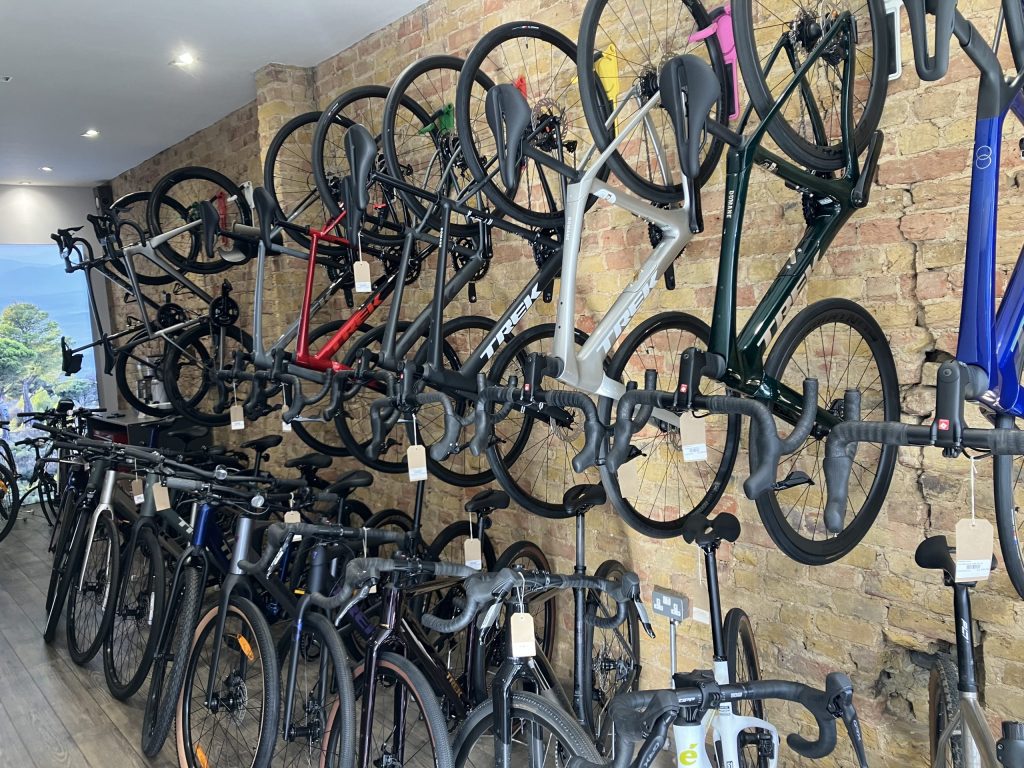 A bike rack inside Richmond Cycles, with predominantly darker coloured bikes. (Credit: Dan Dury)