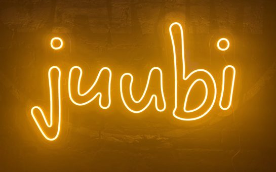 Juubi sign in fluorescent orange - sign of the new grassroots music Collective