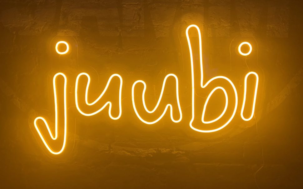 Juubi sign in fluorescent orange - sign of the new grassroots music Collective