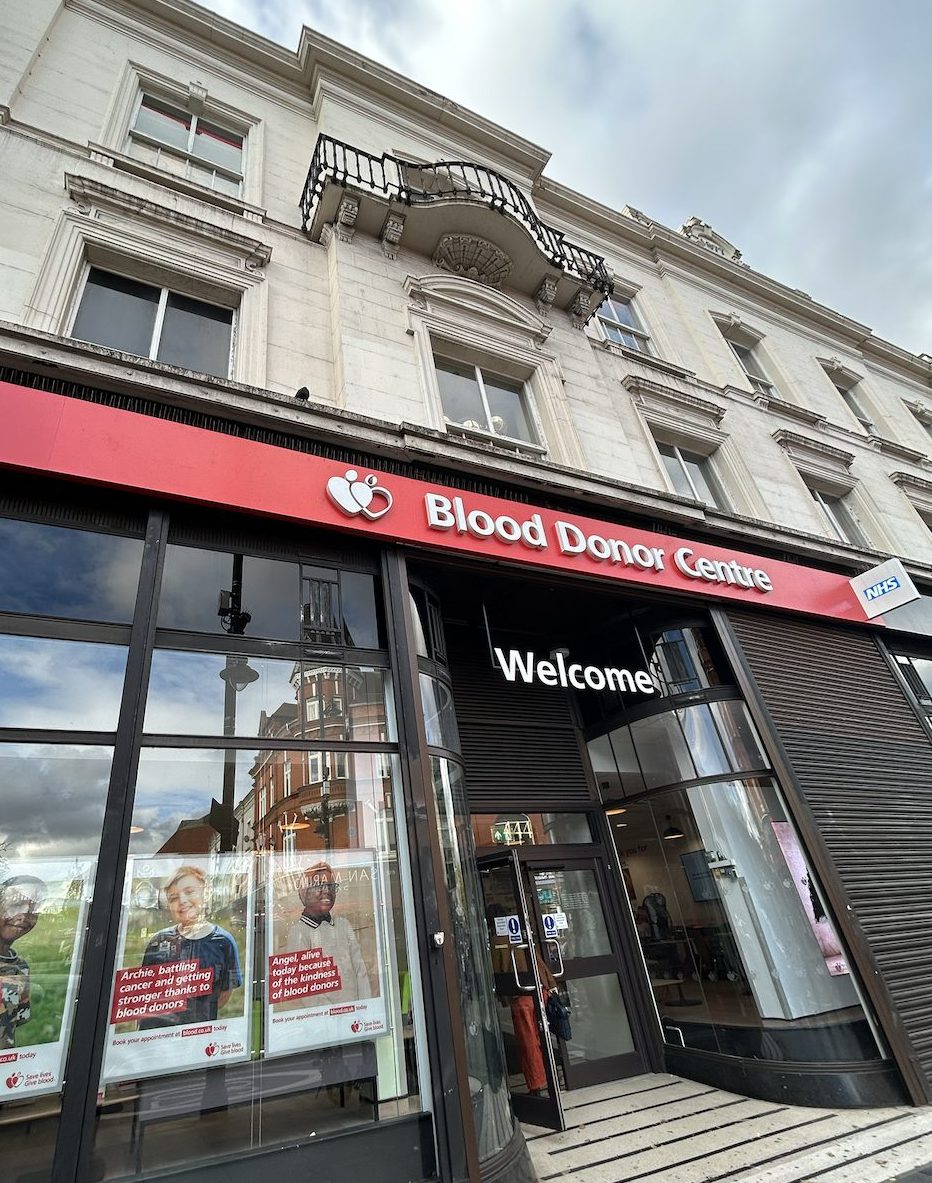 A photograph of the exterior of Brixton blood donor centre. A regency build with a red sign.