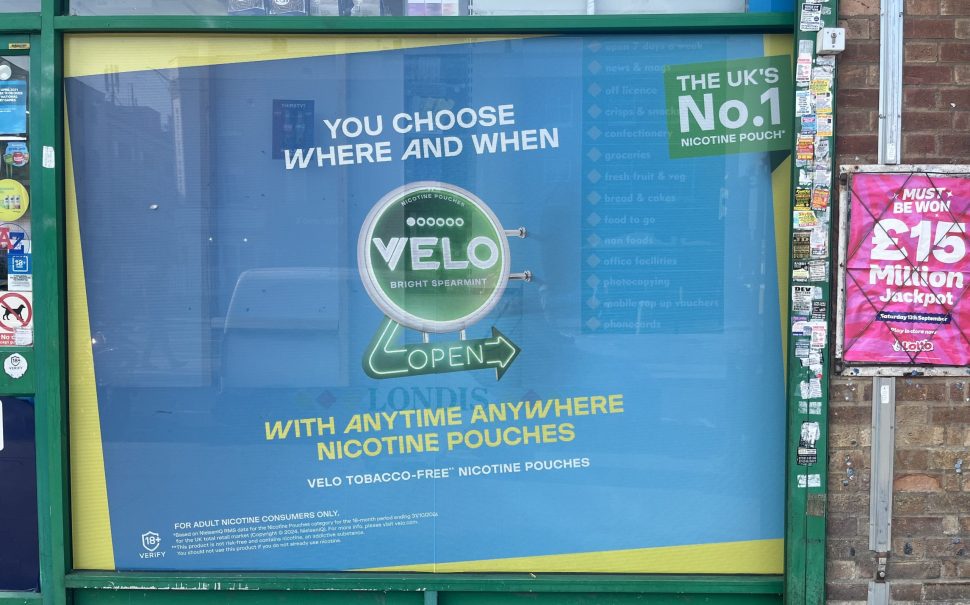 An image of velo advertisement as usable anytime anywhere outside a cornershop.