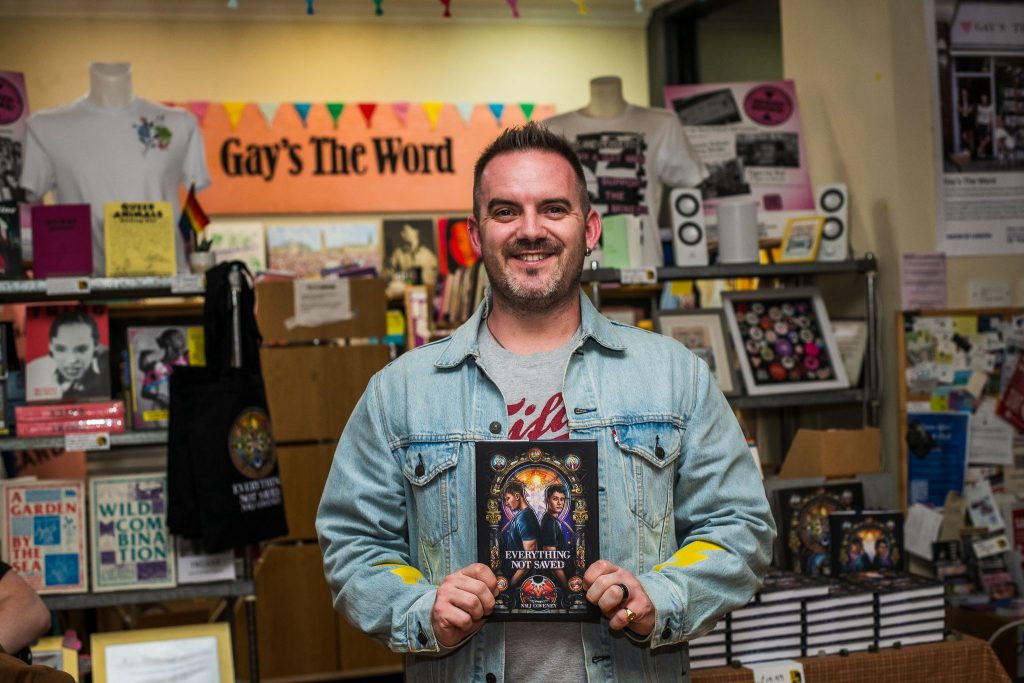 Author Nick Coveney holding his debut novel Everything Not Saved