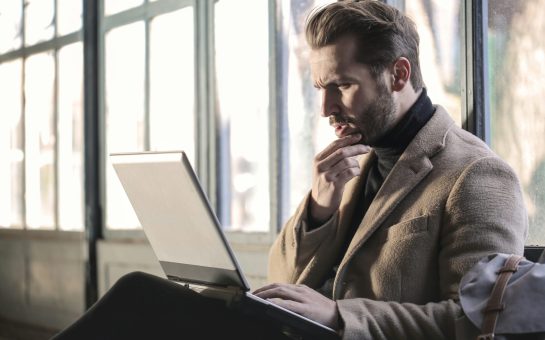 Man holding his chin facing laptop computer (Credit: Free to use from Unsplash)