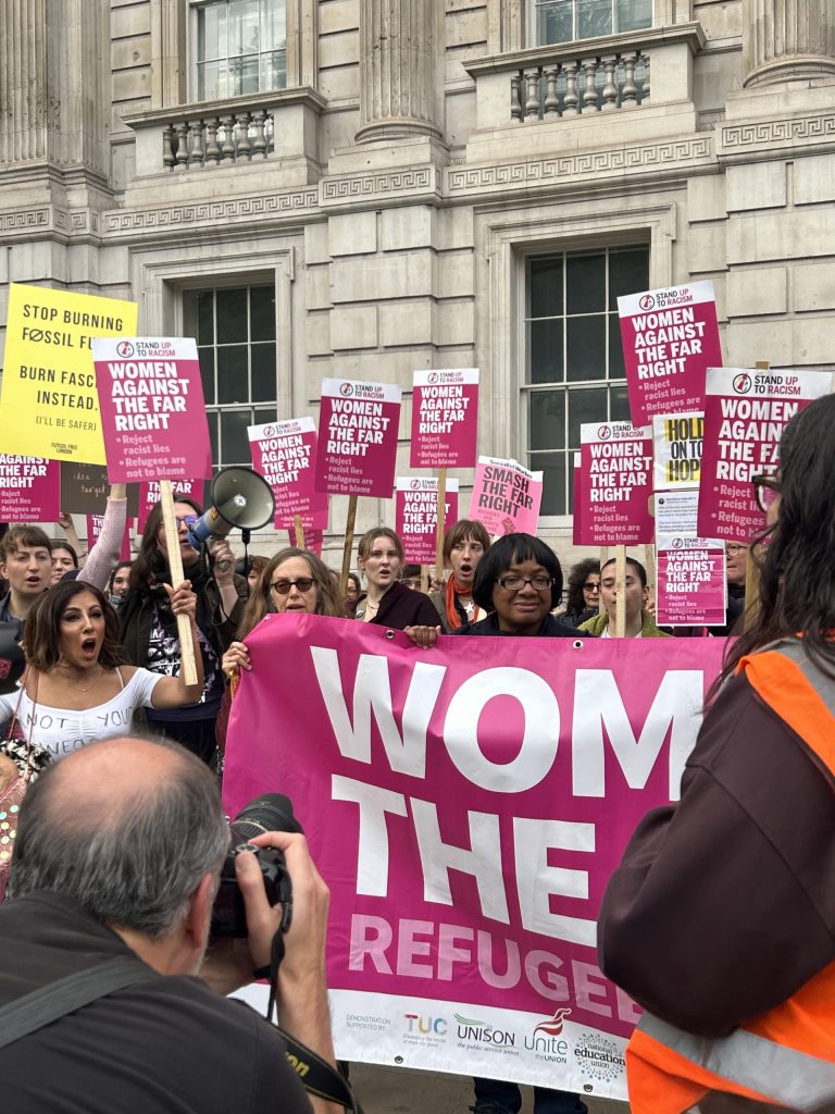 MP Diane Abbott and TV presenter Narinder Kaur pictured among 'Women Against the Far-Right' counter-protest in Westminster. They hold a pink sign titled 'Women against the Far-Right'. 