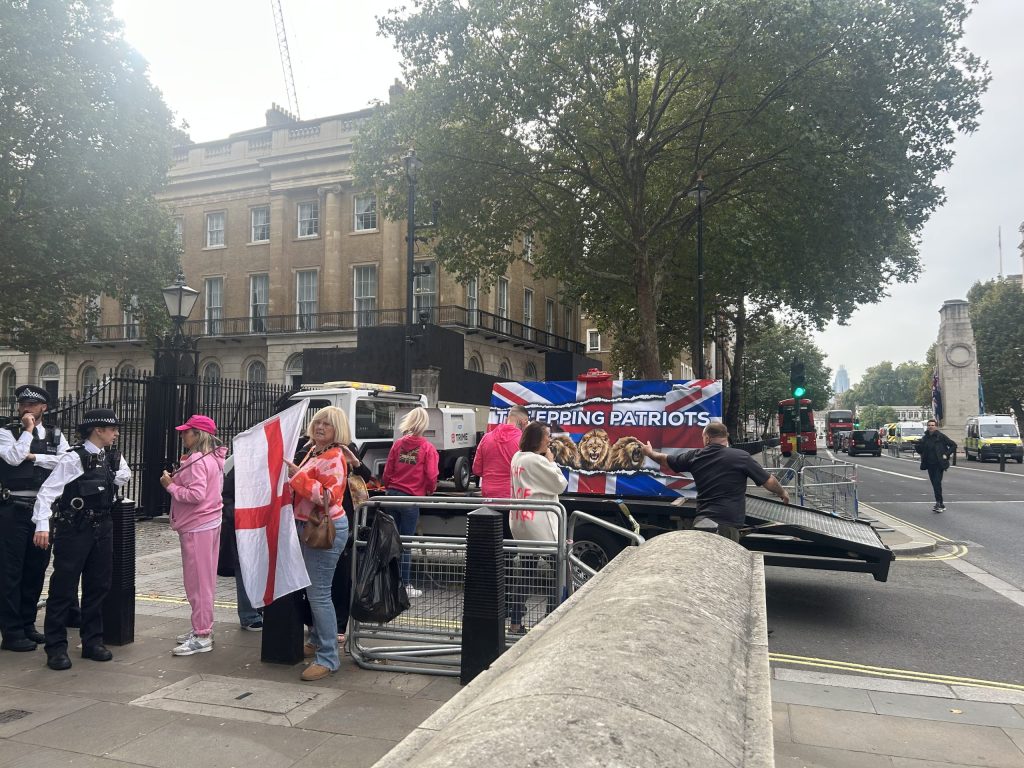 A lorry carrying a large Union Jack flag emblazoned with the words ‘The Epping Patriots’ parked alongside the 'Pink Ladies' protest by Downing Street.