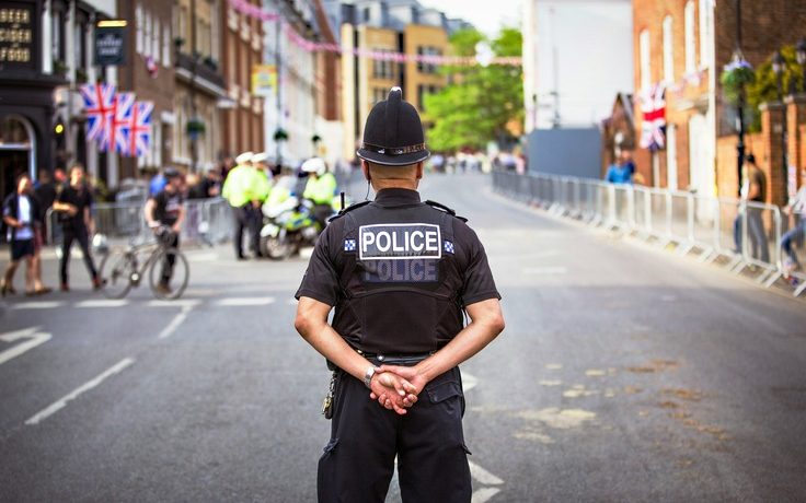 An image of a policeman standing in the middle of the road