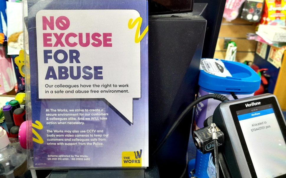 Sign warning against abusing staff in Feltham shop