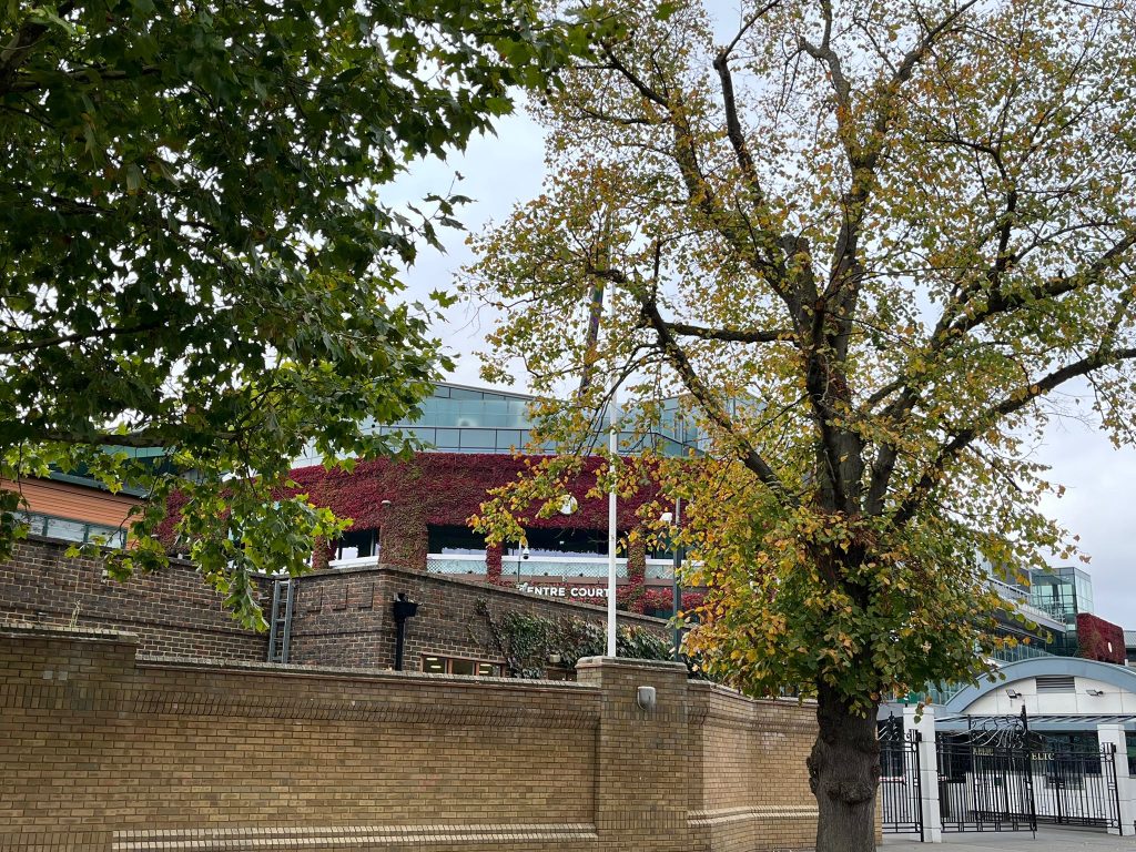 Centre Court at Wimbledon through the trees on the street