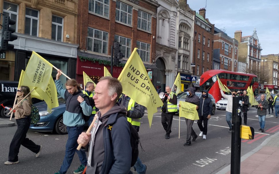 London bus drivers march to TfL headquarters carrying flags and banners.