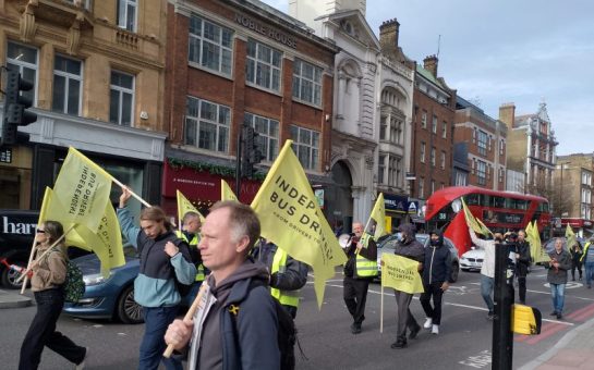 London bus drivers march to TfL headquarters carrying flags and banners.