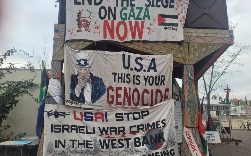 Banners adorning the side of the encampment, documenting the displeasure of Israel's actions in Gaza.