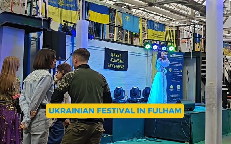 The stage at Toloka festival, with Ukrainian flags draped above, and onlookers watching on.