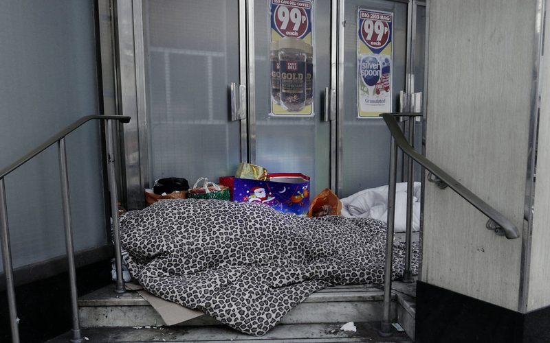 Two homeless people sleeping on the streets in Woolwich, London.