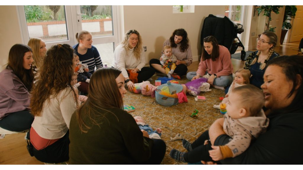 Mums sit in circle with their babies