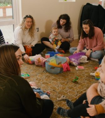 Mums sit in circle with their babies
