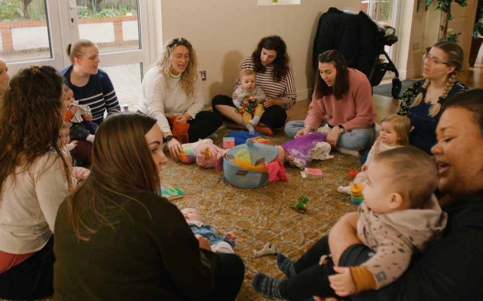 Mums sit in circle with their babies