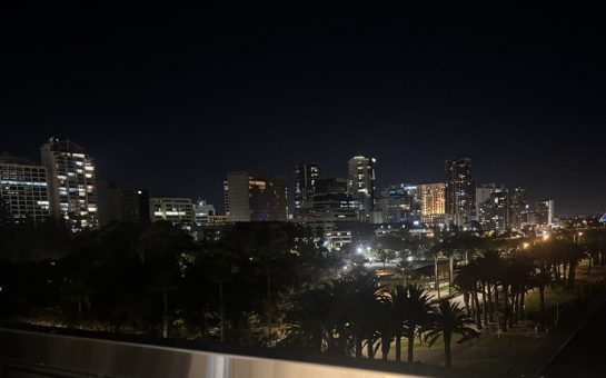 Perth city skyline with buildings lit up against the dark sky.