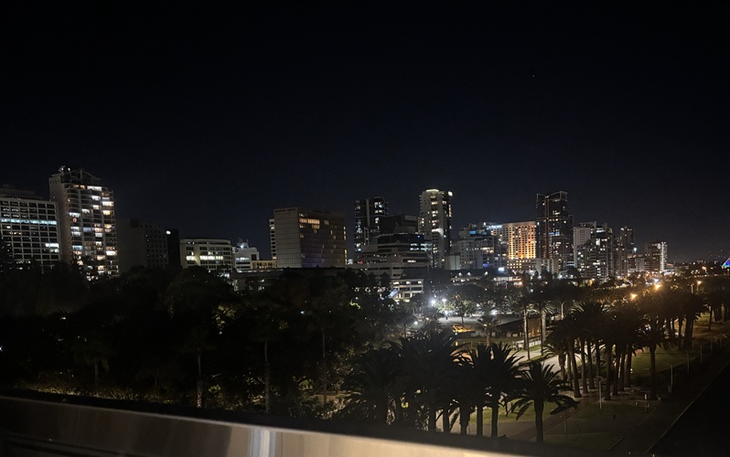 Perth city skyline with buildings lit up against the dark sky.