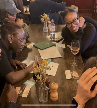 a group of young adults completing trivia at a pub
