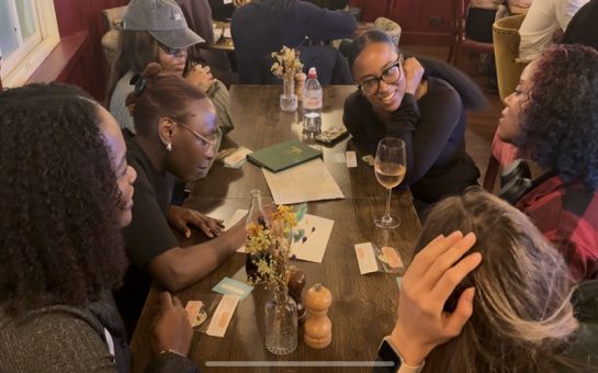 a group of young adults completing trivia at a pub