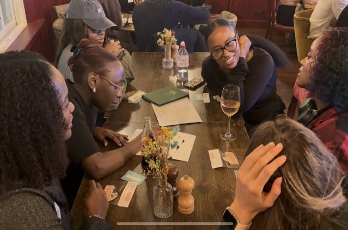 a group of young adults completing trivia at a pub
