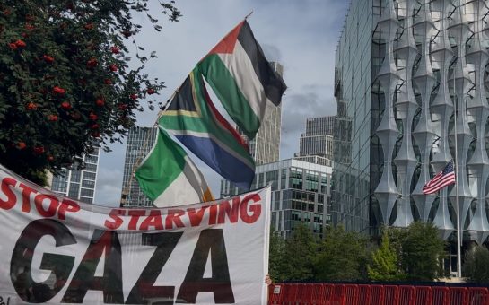 Protest banner reading ‘Stop Starving Gaza’ displayed outside the US Embassy in Nine Elms, London, during Community Camp 4 Palestine demonstration.