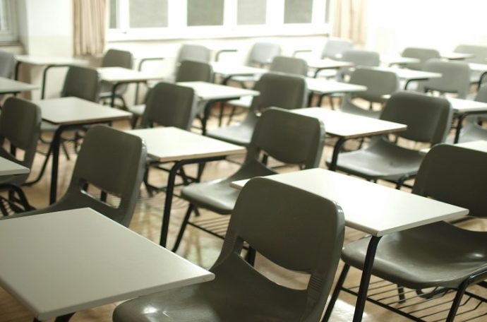 Desks and chairs in an empty school classroom.