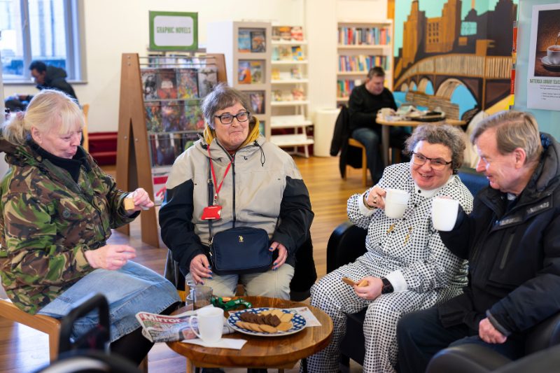 Wandsworth residents enjoying a warm drink whilst chatting in the warmth of their local library.