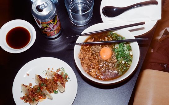 Table with ramen, gyoza and drinks at a restaurant
