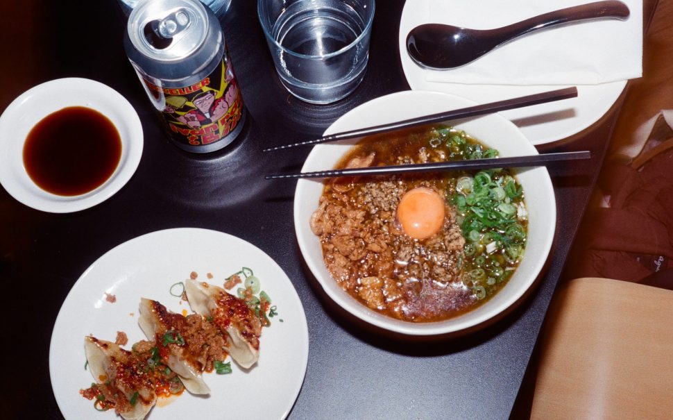 Table with ramen, gyoza and drinks at a restaurant