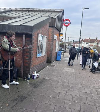 Man performs to crowd outside tube station