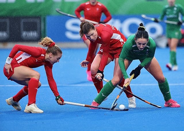 Women playing hockey