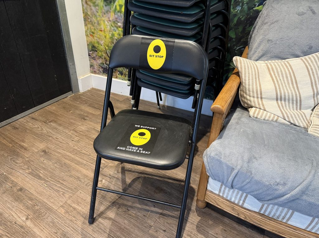 A chair where passer-bys can come and sit for a moment.