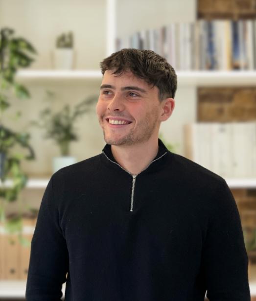 Image of Alex Mccann smiling off to the side