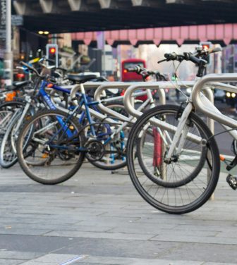 Several bikes parked on a high street