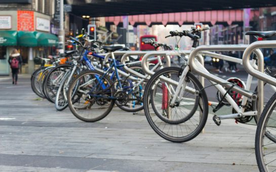 Several bikes parked on a high street