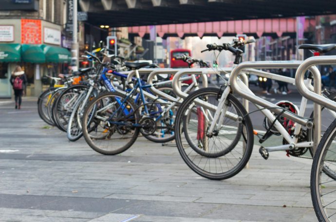 Several bikes parked on a high street