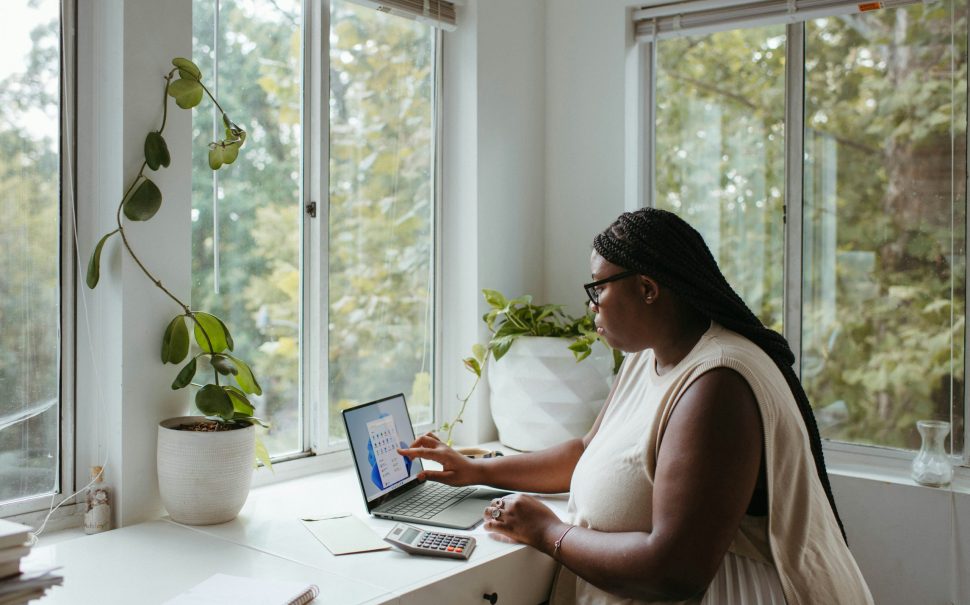 This photo is of a women, working from home on her laptop.