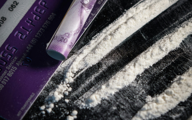 Powdered drug in lines with card and rolled £20 note on the side