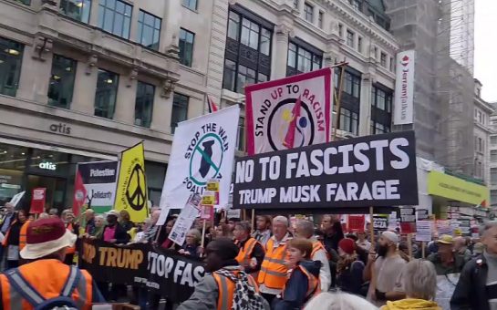 Demonstrators march through London carrying banners protesting Donald Trump, Elon Musk, and Nigel Farage.