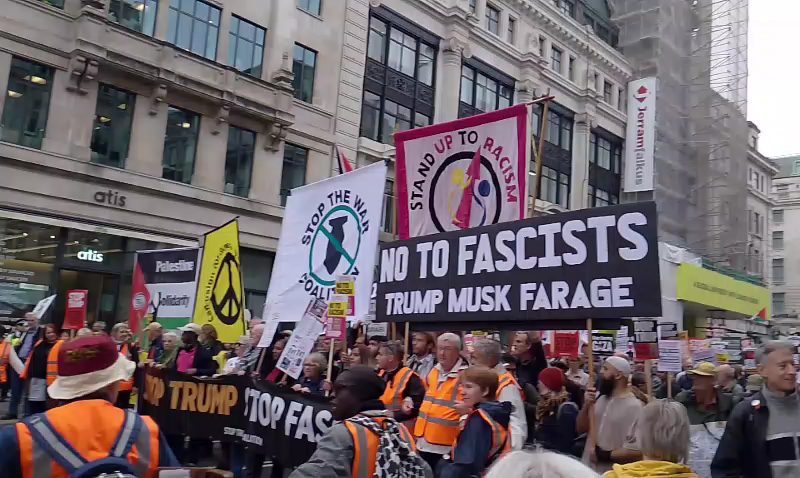 Demonstrators march through London carrying banners protesting Donald Trump, Elon Musk, and Nigel Farage.