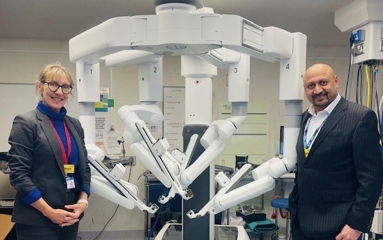 Two medical professionals with the Da Vinci surgery robot.