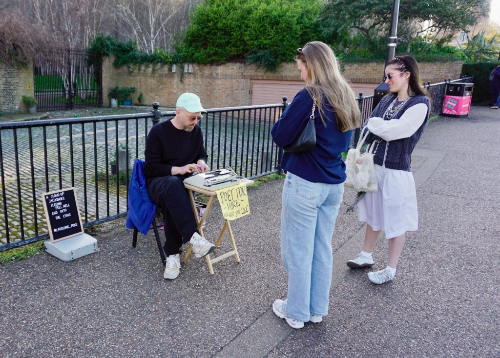 WORD PLAY: Luke writes poems for people based on a brief and gives them a typed copy to take home. Image credit: Louis Greaves