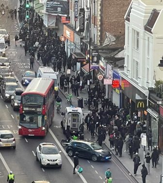busy high street with lots of people and cars